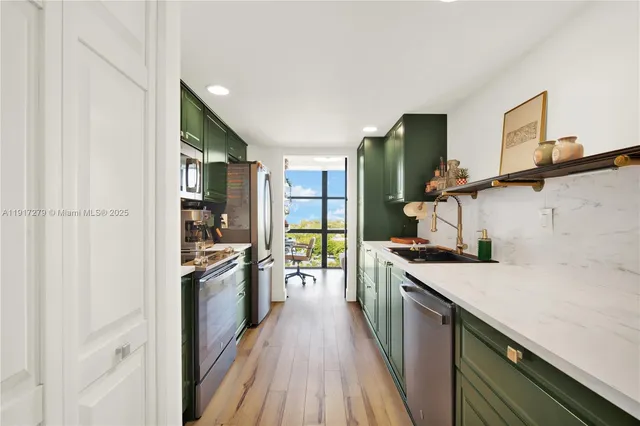 a kitchen with a sink and wooden floor