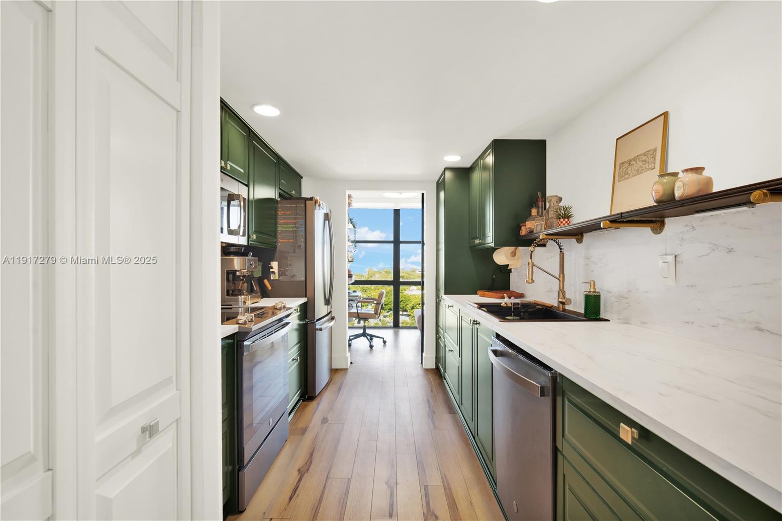 1915 Brickell Avenue, Unit C1101 Miami, FL 33129 - Photo 8 of 55 a kitchen with a sink and wooden floor
