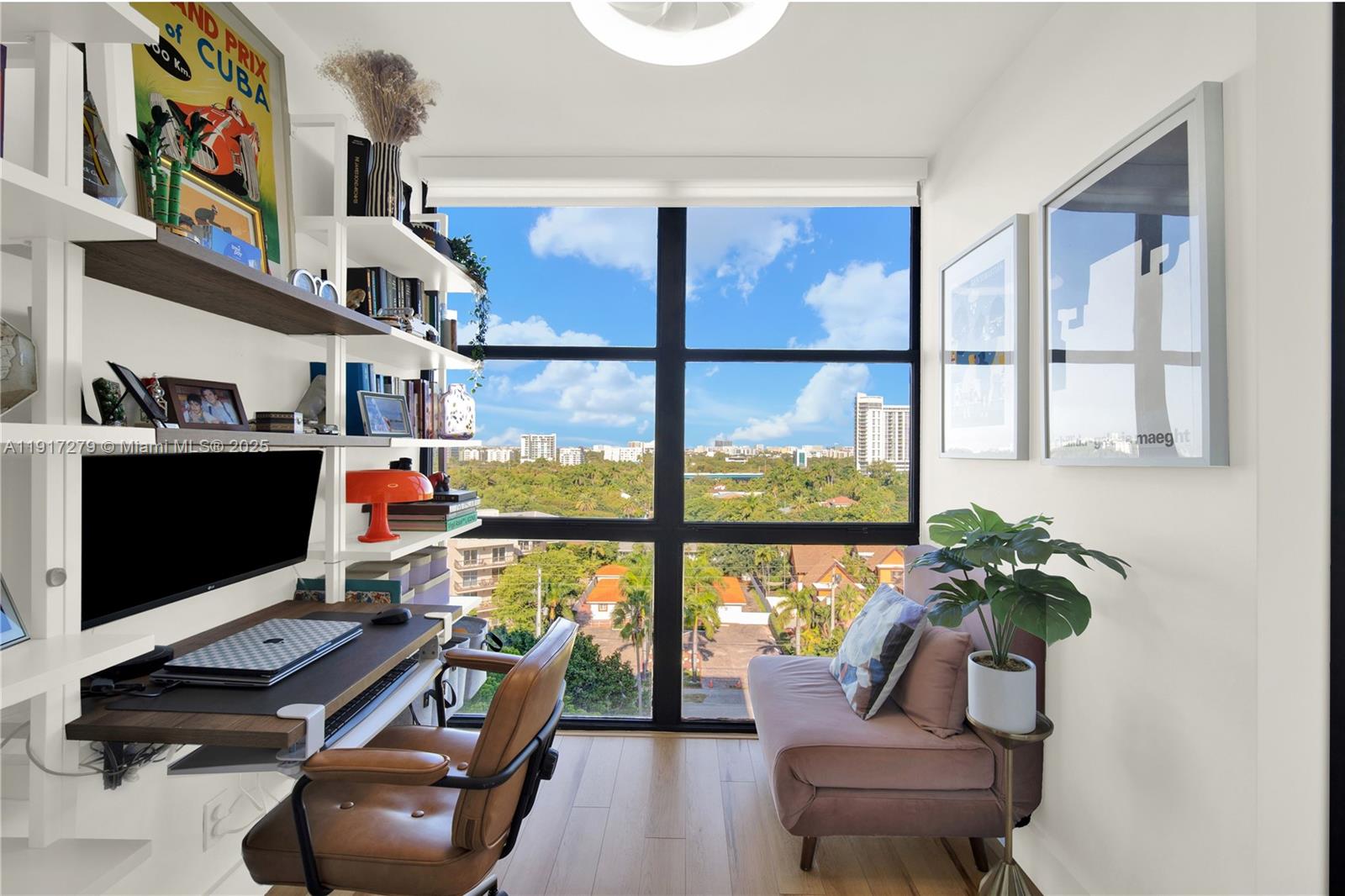 1915 Brickell Avenue, Unit C1101 Miami, FL 33129 - Photo 10 of 55 a living room with furniture a flat screen tv and a floor to ceiling window