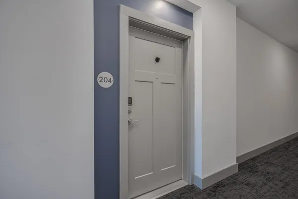 a view of a hallway with wooden floor