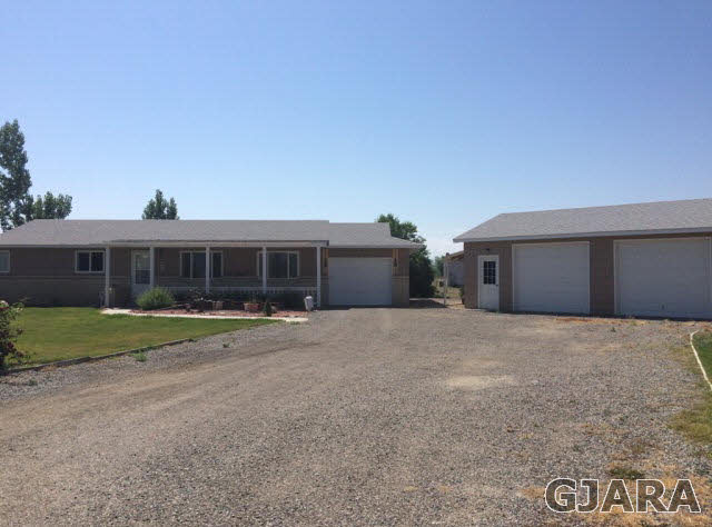 4302 1900th Road Delta, CO 81416 - Photo 1 of 19 a front view of a house with a yard and garage
