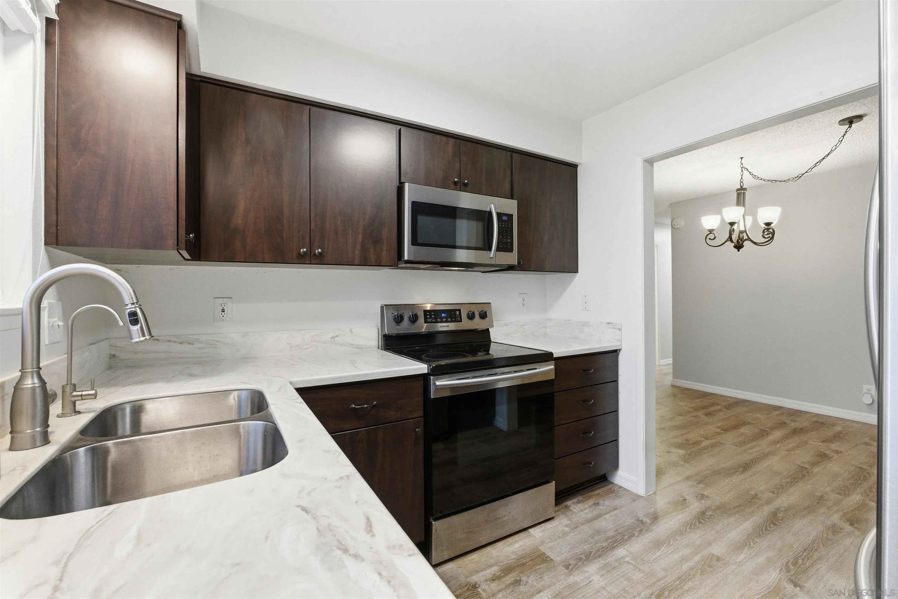 3625 Dearborn Street Oceanside, CA 92057 - Photo 11 of 30 a kitchen with granite countertop a stove and a sink with granite countertops