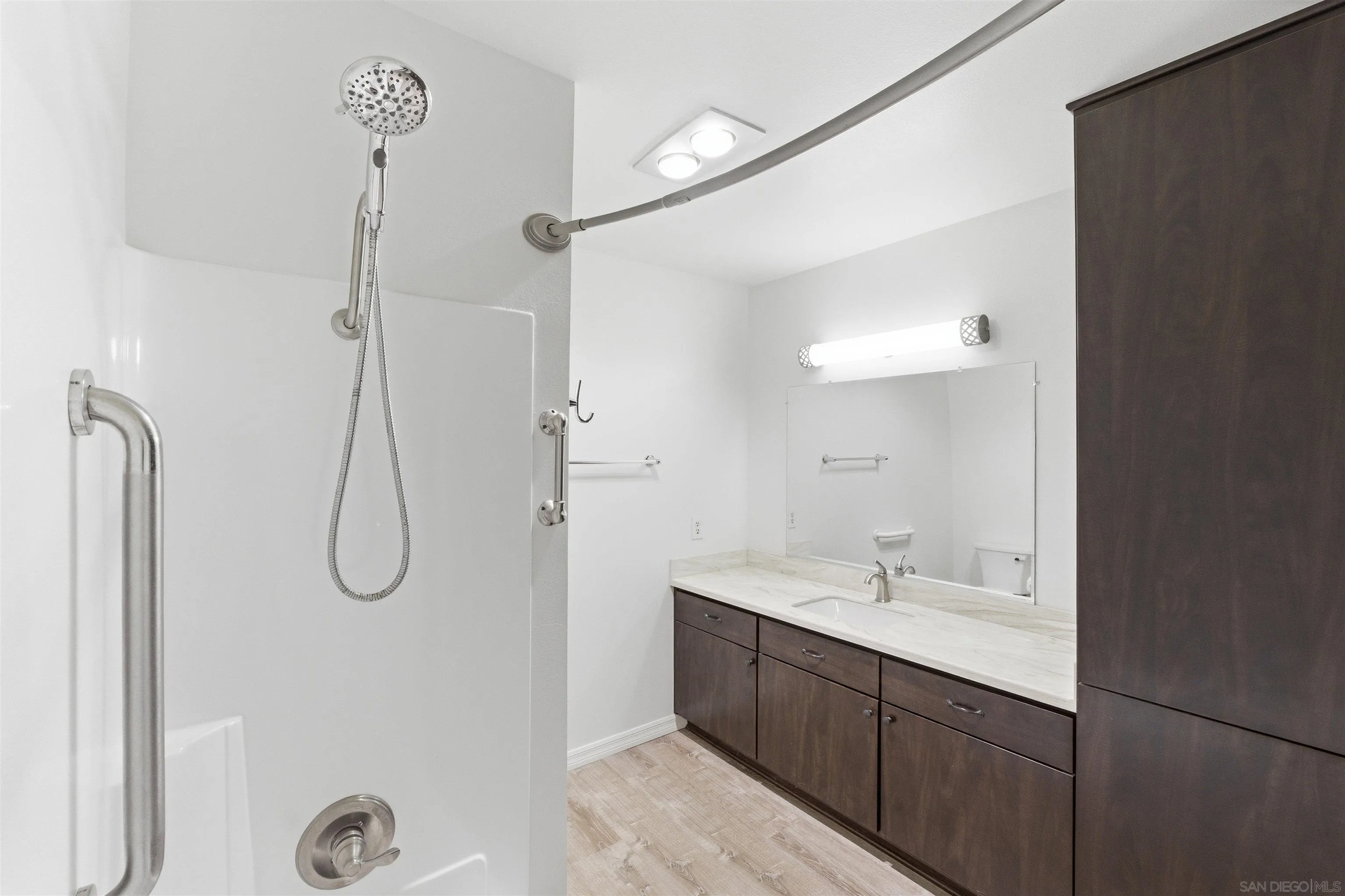 3625 Dearborn Street Oceanside, CA 92057 - Photo 21 of 30 a bathroom with a shower sink and mirror