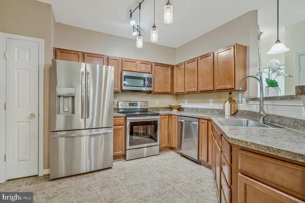 a bedroom with a large bed and a flat tv screen on dresser