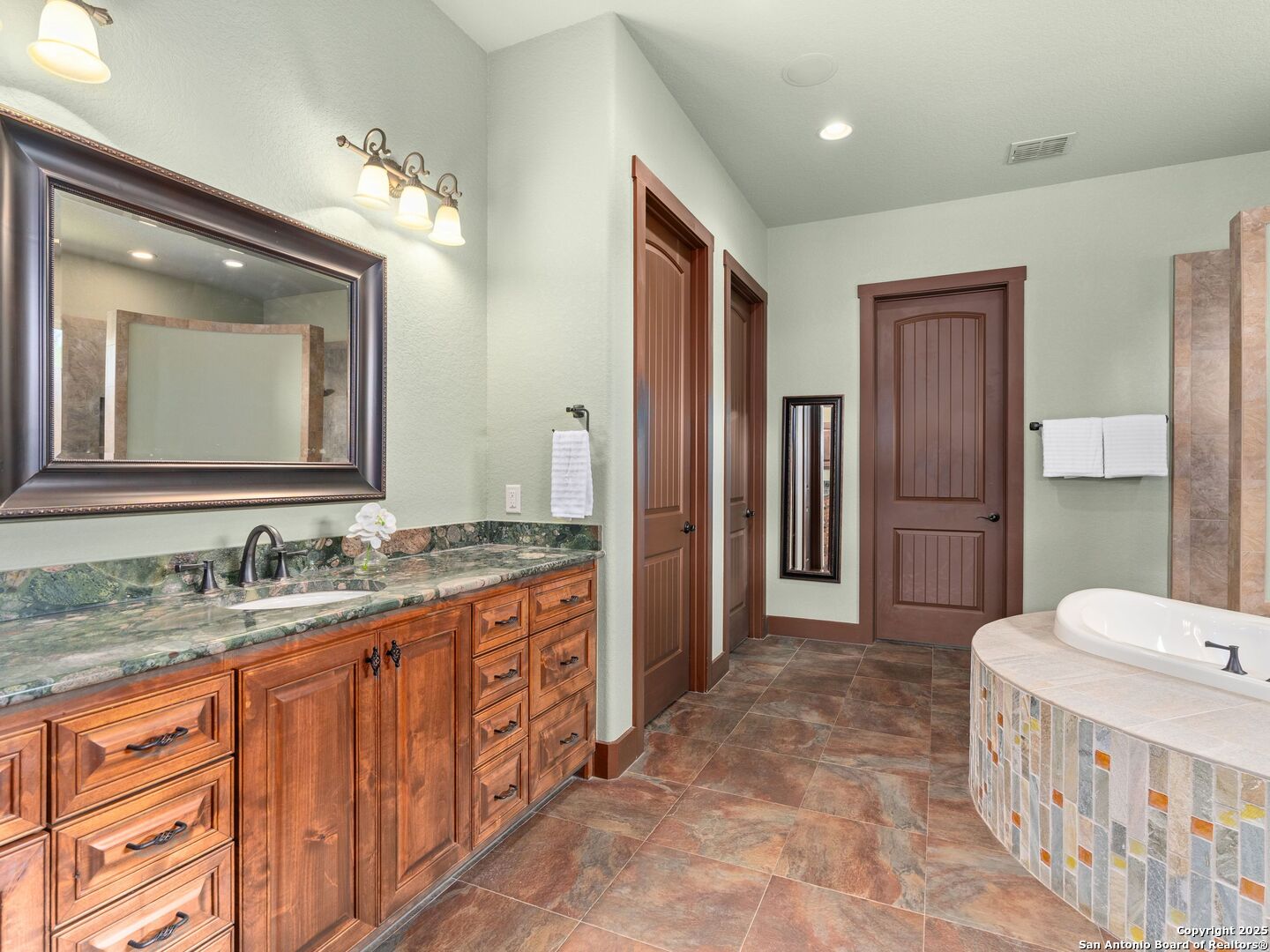 103 Falcon Crest Boerne, TX 78006 - Photo 18 of 35 a bathroom with a sink a toilet and mirror