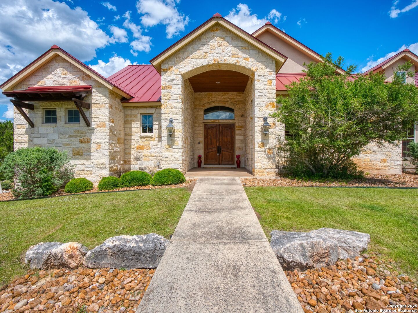 103 Falcon Crest Boerne, TX 78006 - Photo 2 of 35 a front view of a house with garden