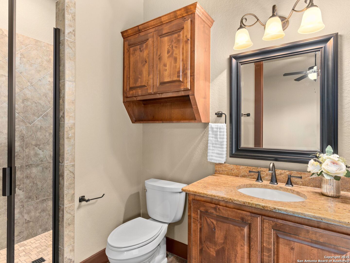 103 Falcon Crest Boerne, TX 78006 - Photo 25 of 35 a bathroom with a granite countertop sink vanity mirror and toilet