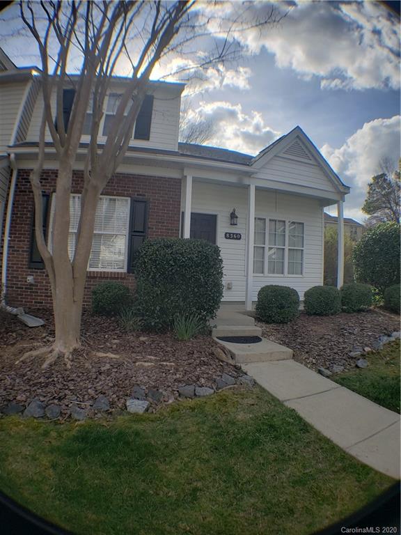 a view of a house with a small yard and plants