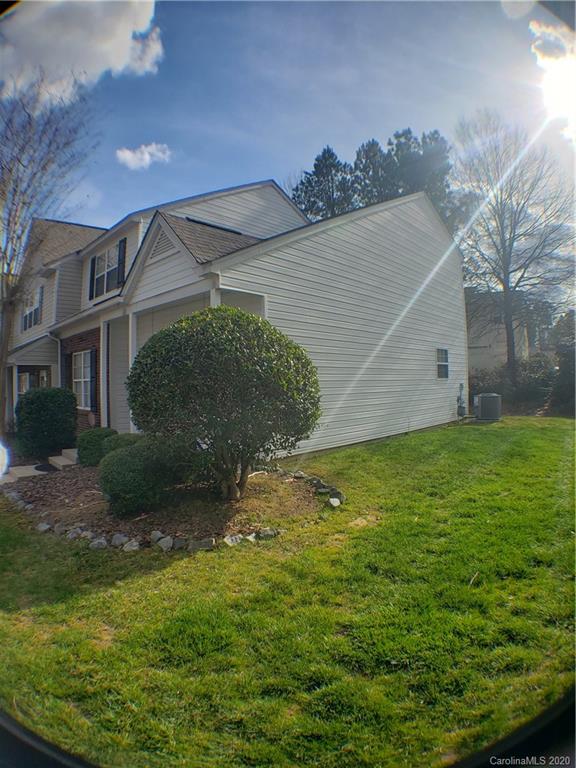 8360 Rudolph Road, Unit 2105 Charlotte, NC 28216 - Photo 2 of 14 a view of a big house with a yard
