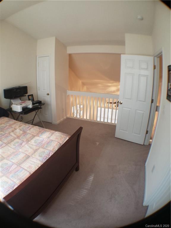 8360 Rudolph Road, Unit 2105 Charlotte, NC 28216 - Photo 11 of 14 a bedroom with a bed and a window