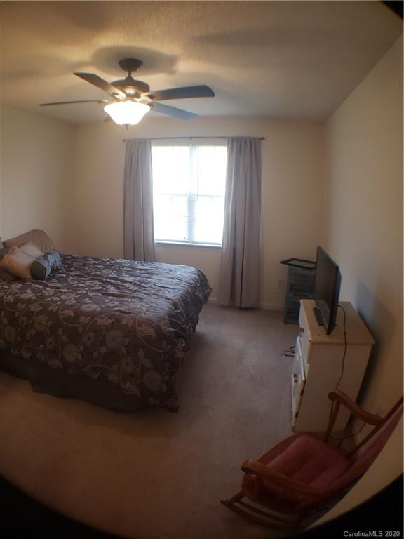 8360 Rudolph Road, Unit 2105 Charlotte, NC 28216 - Photo 12 of 14 a bed sitting in a room next to a window