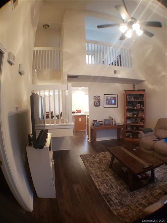 8360 Rudolph Road, Unit 2105 Charlotte, NC 28216 - Photo 4 of 14 a living room with furniture and a chandelier