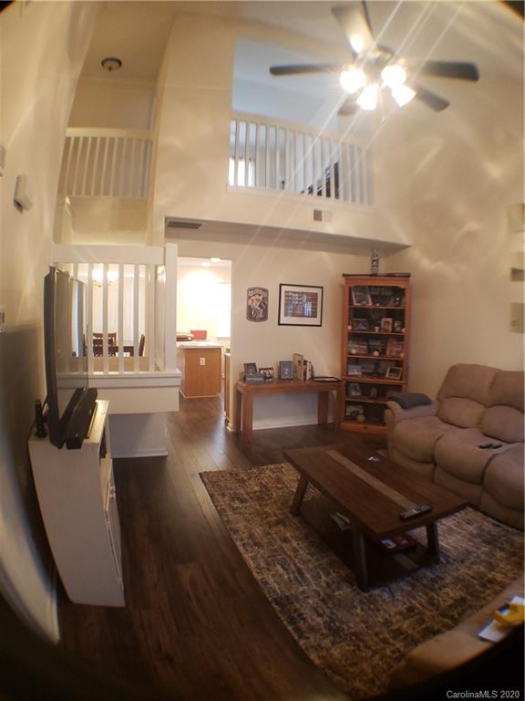 8360 Rudolph Road, Unit 2105 Charlotte, NC 28216 - Photo 5 of 14 a living room with furniture and a dining table