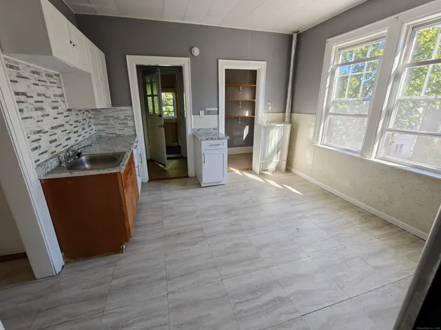 wooden floor in an empty room with a fireplace