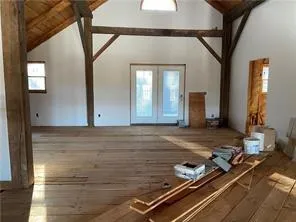 a view of an empty room with a fireplace and windows