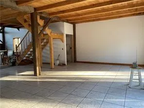 a view of an empty room with a fireplace and windows