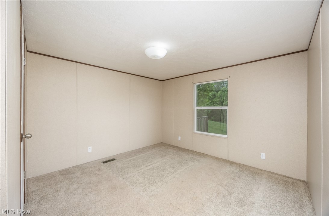 7455 Stanleyville Road Whipple, OH 45788 - Photo 27 of 37 Neutral-toned bedroom with carpet flooring, a single window, and a flush-mount ceiling light fixture