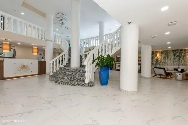 a view of a hallway with dining area and chandelier