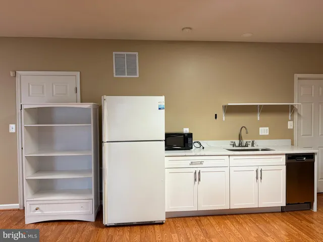 a large bed sitting in a bedroom next to a window