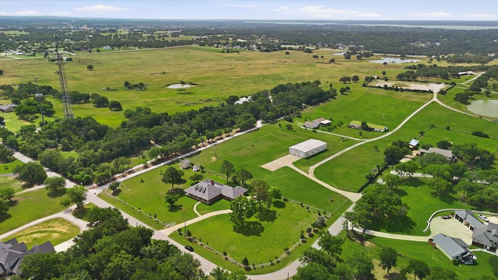 6955 Hawk Road Flower Mound, TX 75022 - Photo 39 of 40 Expansive aerial showcasing a large land parcel featuring a main residence, an additional structure, and multiple ponds