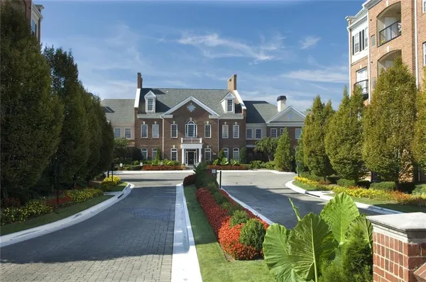 a front view of a house with yard and green space