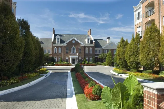 a front view of a house with yard and green space