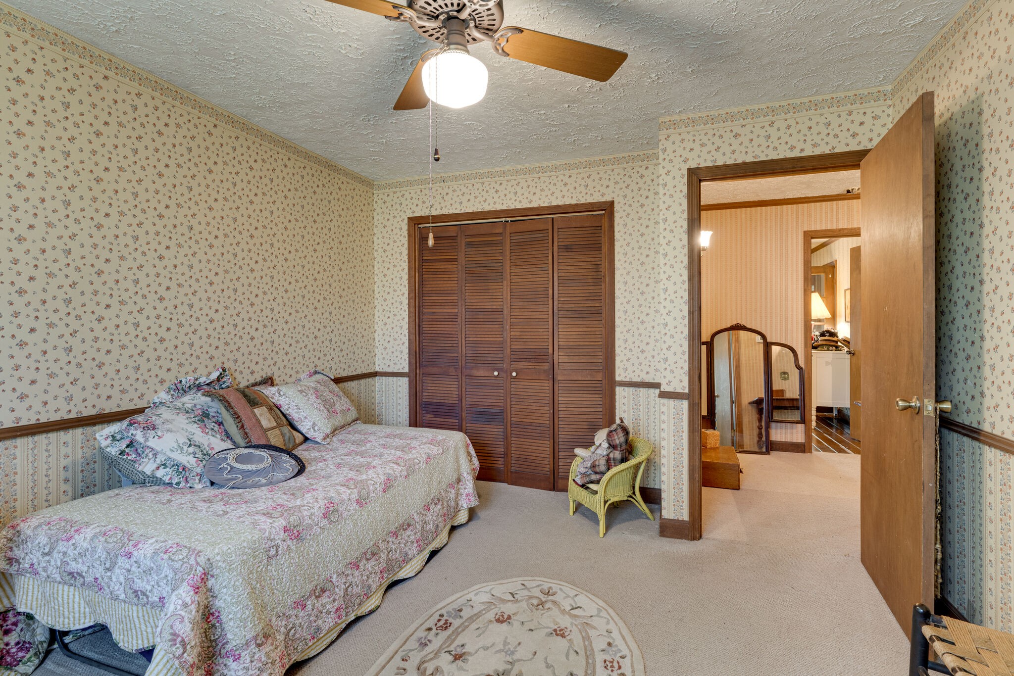2729 Gideon Road Greenbrier, TN 37073 - Photo 18 of 30 a spacious bedroom with a bed a couch and a chandelier