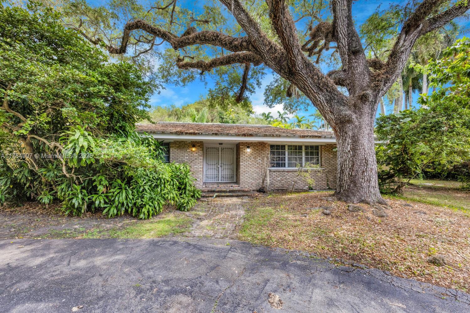 4151 Douglas Road Miami, FL 33133 - Photo 13 of 24 a front view of a house with garden