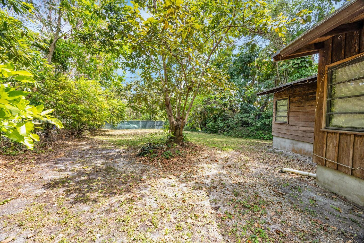 4151 Douglas Road Miami, FL 33133 - Photo 22 of 24 a view of backyard with green space