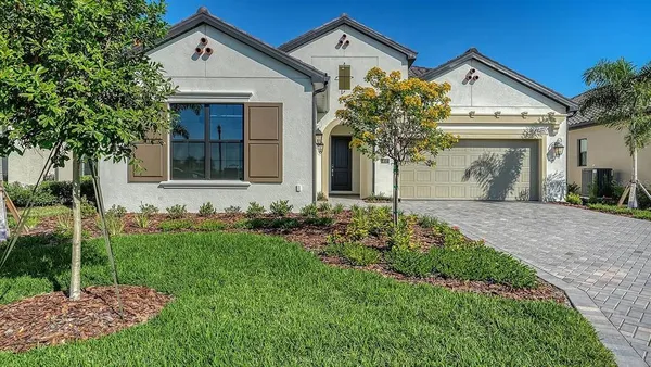 a front view of a house with a yard and garage