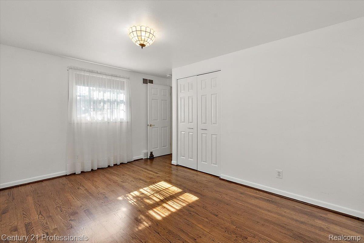 633 Foxhall Road Bloomfield Hills, MI 48304 - Photo 52 of 61 Hardwood flooring paired with a classic white trim