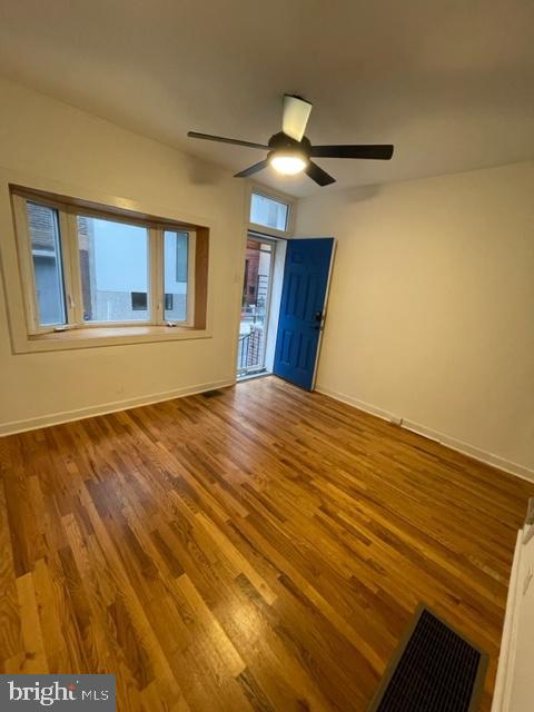 1750 Waterloo Street Philadelphia, PA 19122 - Photo 2 of 15 a view of an empty room with wooden floor and a window