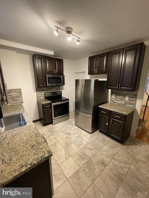 1750 Waterloo Street Philadelphia, PA 19122 - Photo 3 of 15 a kitchen with stainless steel appliances granite countertop a stove refrigerator and sink