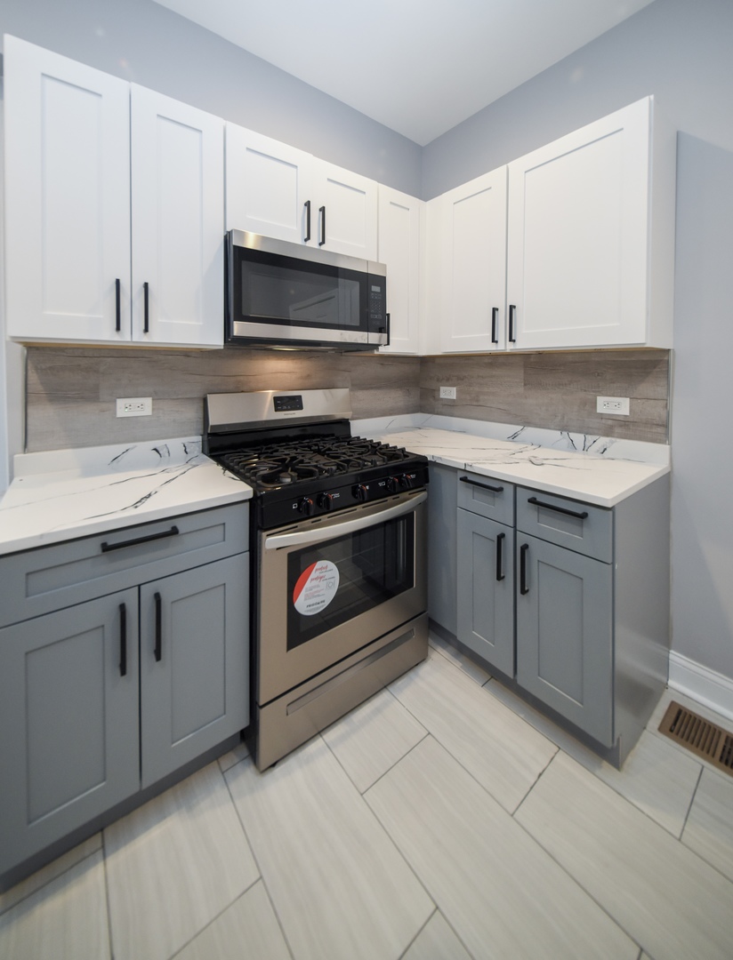 5932 South Elizabeth Street Chicago, IL 60636 - Photo 13 of 25 a kitchen with cabinets appliances and a sink