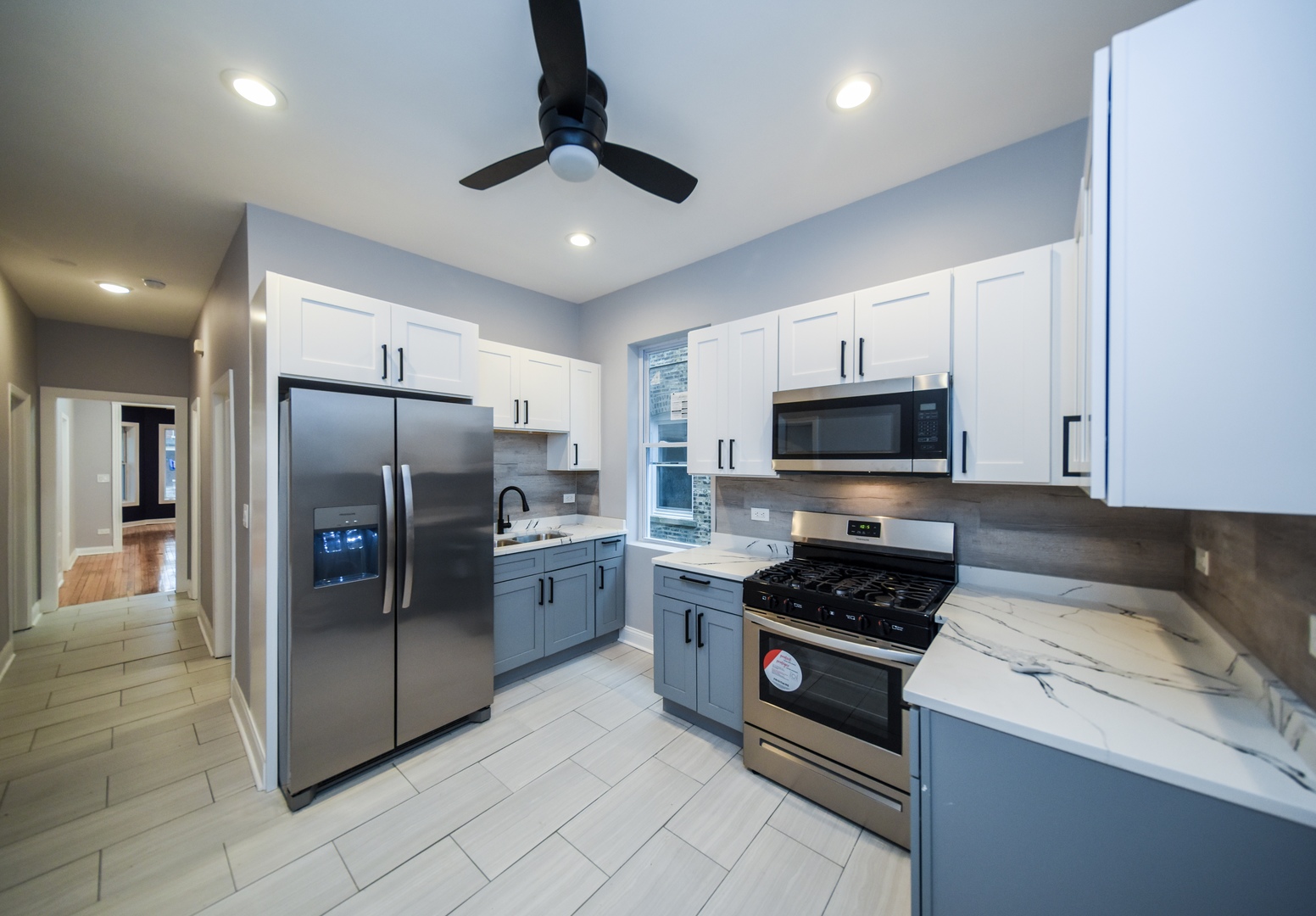5932 South Elizabeth Street Chicago, IL 60636 - Photo 14 of 25 a kitchen with stainless steel appliances granite countertop a refrigerator a stove a sink and a microwave