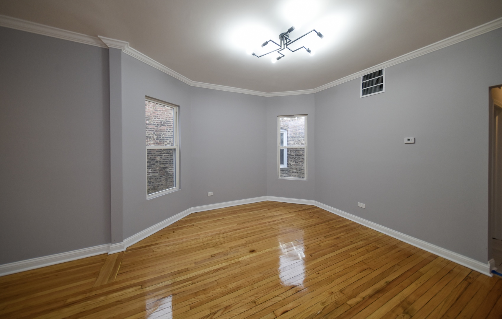 5932 South Elizabeth Street Chicago, IL 60636 - Photo 18 of 25 a view of an empty room with a window and wooden floor