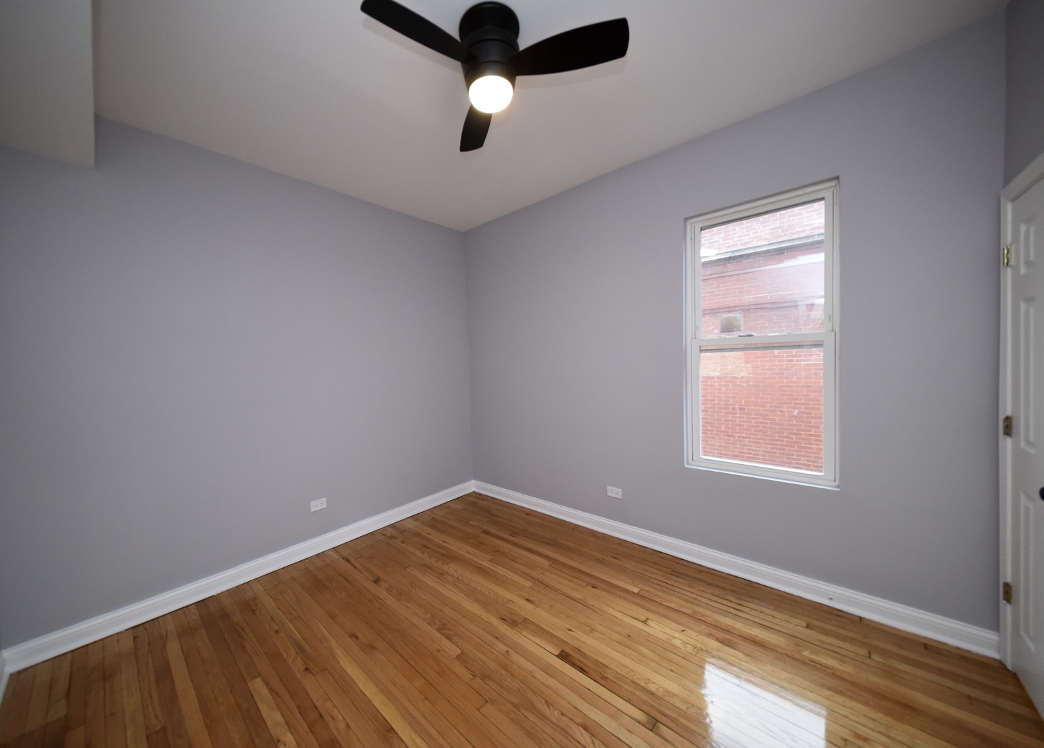 5932 South Elizabeth Street Chicago, IL 60636 - Photo 21 of 25 an empty room with a window and a ceiling fan