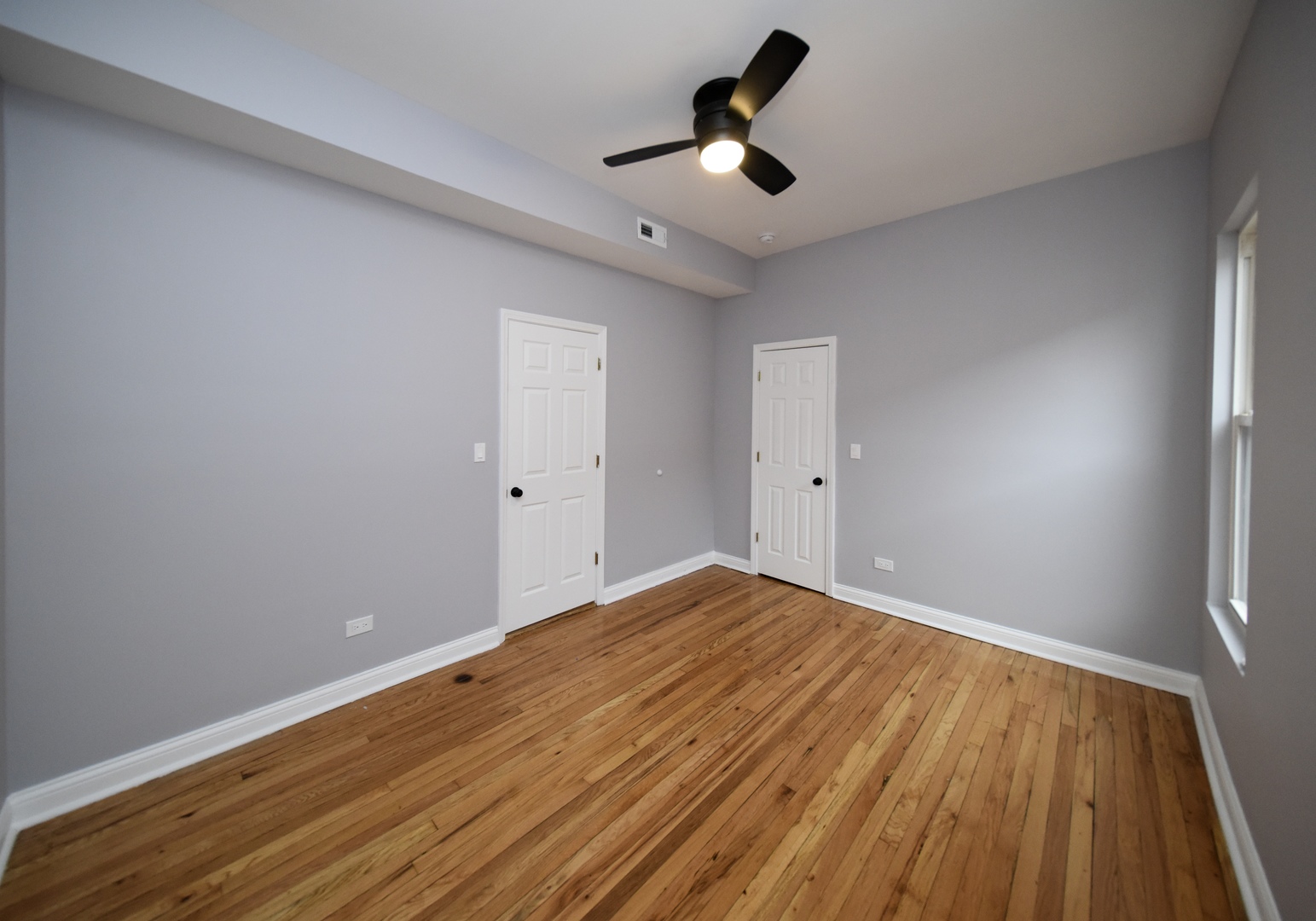 5932 South Elizabeth Street Chicago, IL 60636 - Photo 22 of 25 a view of empty room with wooden floor and fan