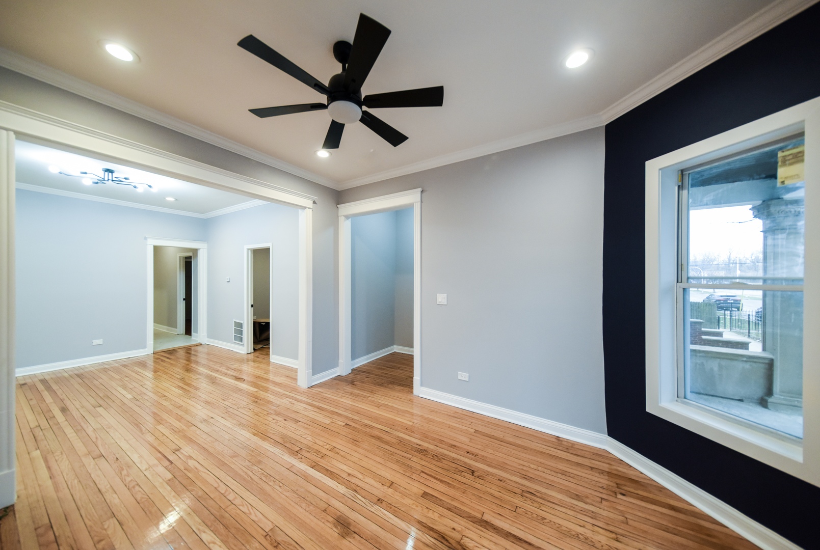 5932 South Elizabeth Street Chicago, IL 60636 - Photo 5 of 25 a view of a livingroom with a ceiling fan and wooden floor