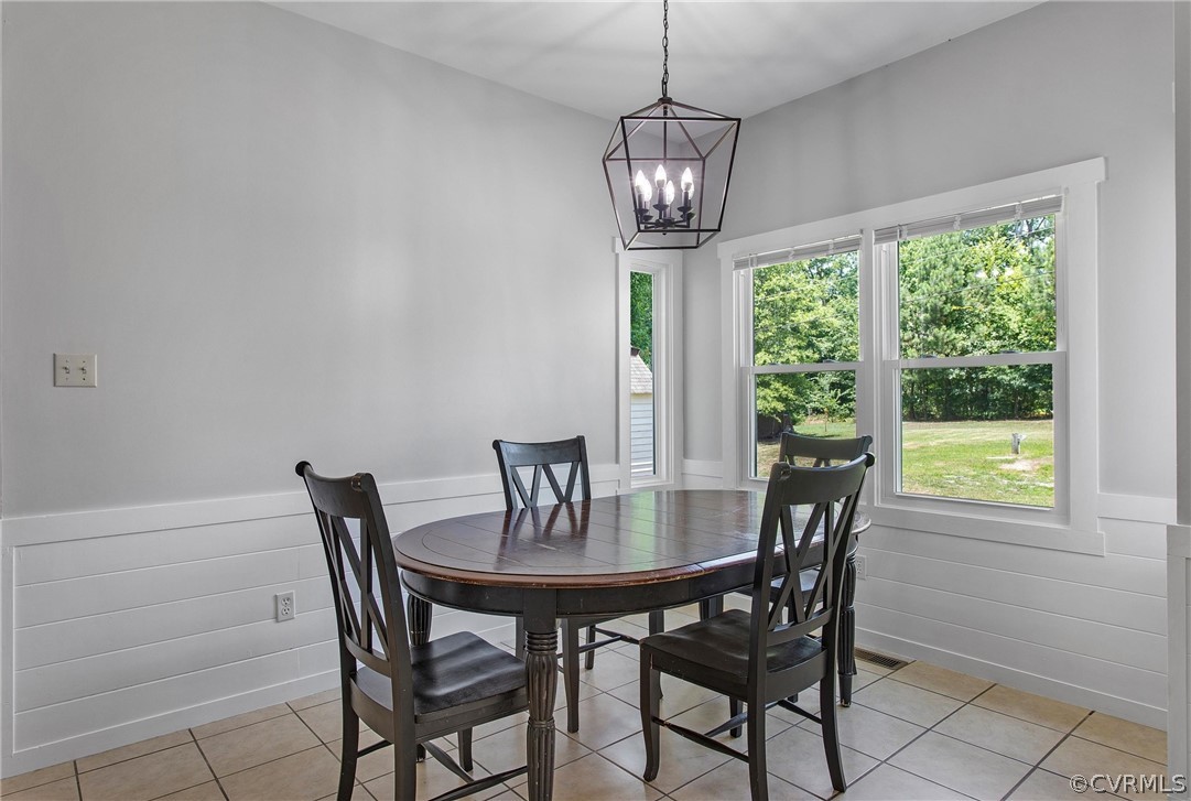 11210 Moravia Road Midlothian, VA 23112 - Photo 13 of 29 a view of a dining room with furniture wooden floor and chandelier