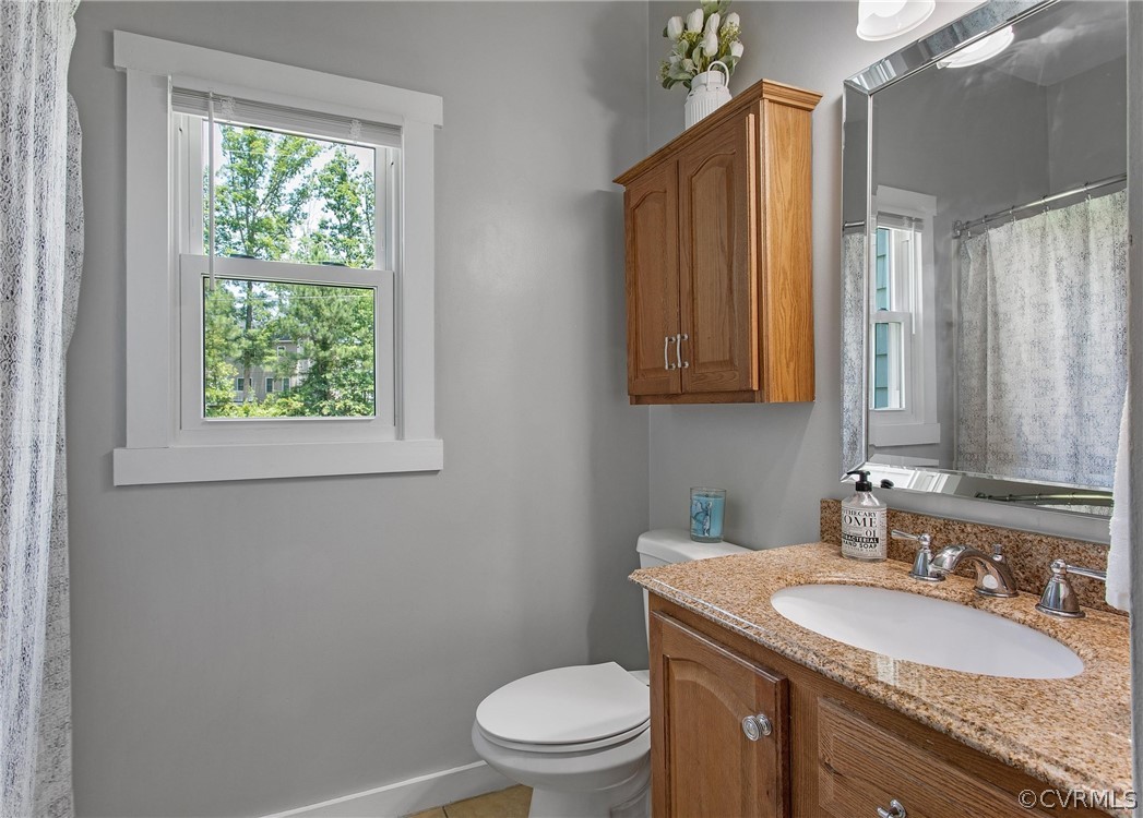 11210 Moravia Road Midlothian, VA 23112 - Photo 17 of 29 a bathroom with a granite countertop sink toilet and mirror