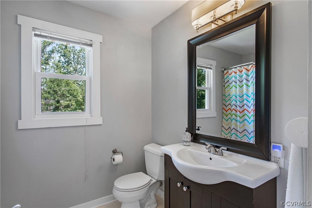 11210 Moravia Road Midlothian, VA 23112 - Photo 20 of 29 a bathroom with a toilet sink and mirror