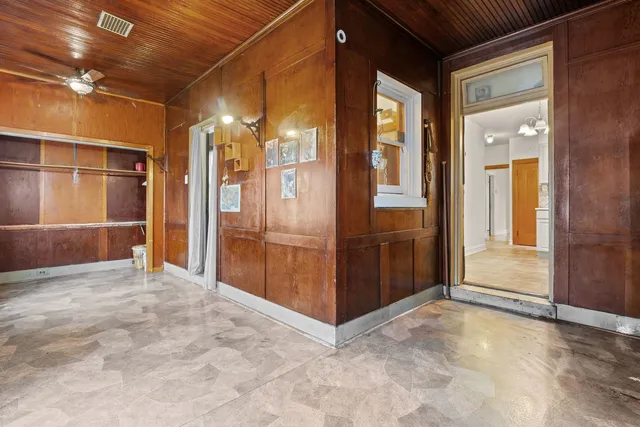 a view of a hallway with wooden shelves