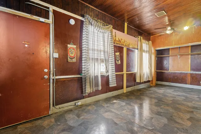 a view of an empty room with wooden door