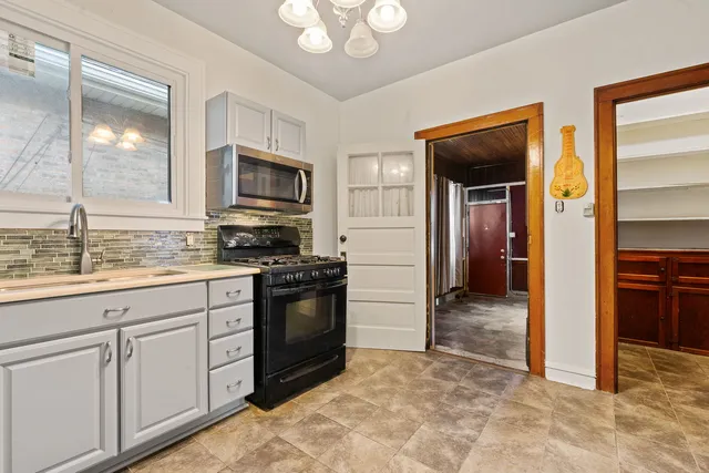 a kitchen with granite countertop a refrigerator and a sink