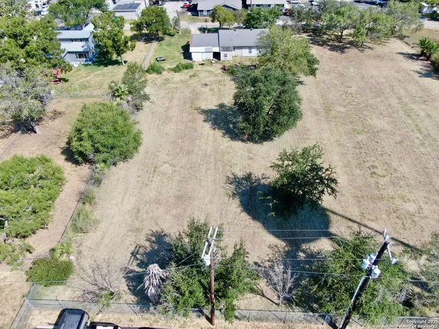 an aerial view of a house with a yard