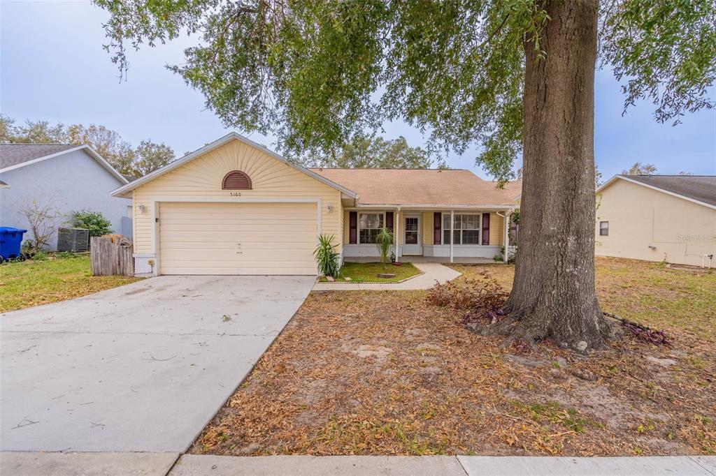 5160 Wood Ridge Court Ocoee, FL 34761 - Photo 1 of 1 a view of a white house with a large tree next to a yard