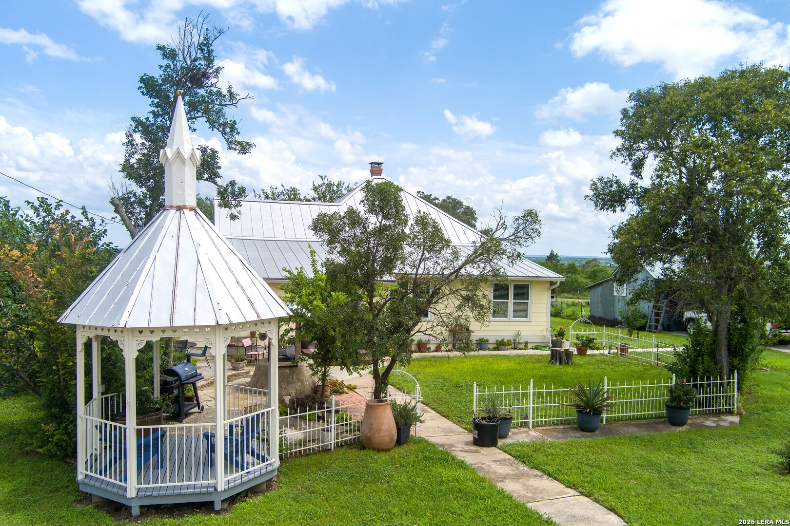 4515 Stapper Road St. Hedwig, TX 78152 - Photo 39 of 64 a front view of a house with a garden and fountain