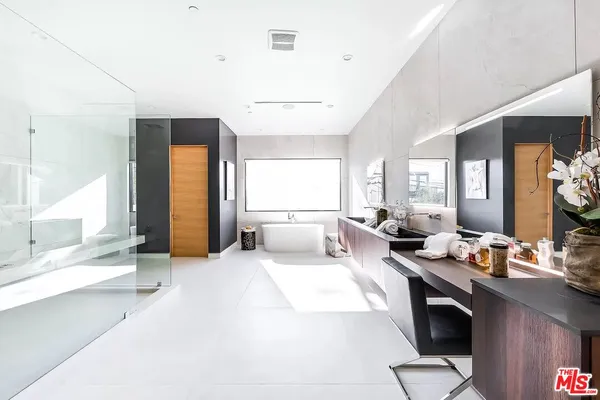 a large bedroom with a bed and large windows