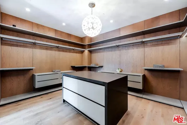 a kitchen with stainless steel appliances granite countertop a sink and a refrigerator